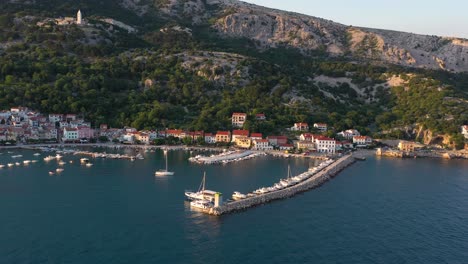 Aerial-shot-looking-across-the-oceanfront-of-a-quiet-village-on-Krk-Island,-Croatia