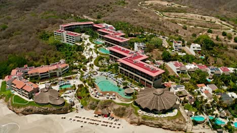 Wide-angle-drone-shot-flying-over-seaside-Puerto-Vallarta-Hotel-Resort