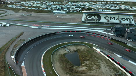 F1-Racing-Cars-Moving-On-A-Sharp-Turn-On-The-Circuit-Of-Zandvoort,-The-Netherlands
