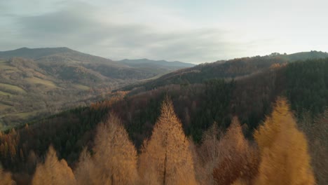 An-aerial-drone-footage-of-a-countryside-with-beautiful-mountains-in-the-background-in-late-autumn