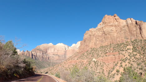 Point-of-view-shot-of-a-car-driving-through-Zion-National-Park,-Utah,-United-States