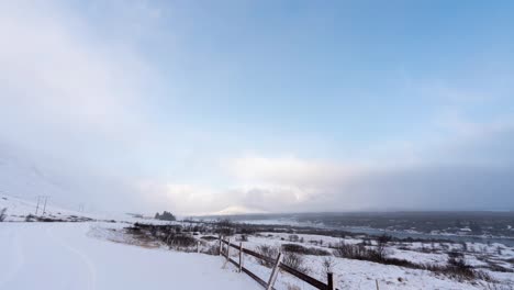 Time-lapse-shot-of-stormy-clouds-flying-over-snowy-Iceland-Island-in-Winter