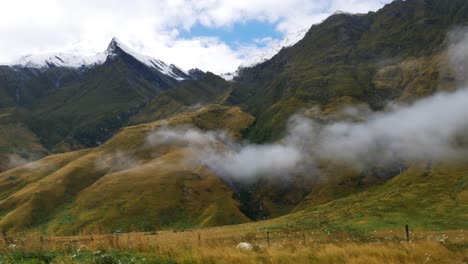 Panorama-shot-of-snowy-Mount-Rob-Roy-in-Mount-Aspiring-National-park-of-New-Zealand-during-sunny-day-and-cloudy-day