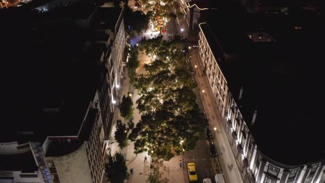 Idyllic-night-time-scenery-above-historic-cute-streets-of-Funchal-in-Madeira,-aerial