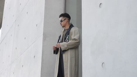 Asian-male-model-posing-in-front-of-modern-concrete-architecture