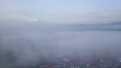 Drone-footage-of-sea-of-fog-above-urban-areas