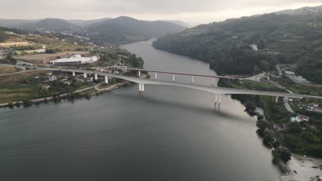 Bridges-over-meandering-Douro-River-against-mountains,-Entre-os-Rios,-Portugal