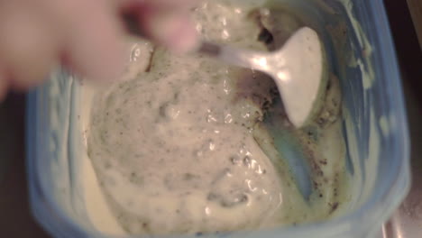 Chocolate-filling-is-chopped-up-with-a-silver-spoon-to-make-pancakes,-close-up