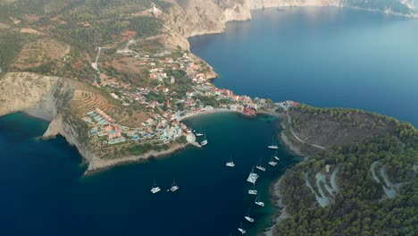 Aerial-view-approaching-beautiful-traditional-greek-village,-Assos-bay,-Kefalonia-Island