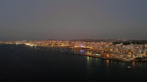 Aerial-drone-video-from-Malta,-St-Pauls'-Bay-and-Bugibba-area-at-twilight