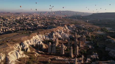 Cappadocia-Turkey-on-Sunny-Morning,-Hot-Air-Balloons-Flying-Above-Scenic-Landscape,-Drone-Aerial-View