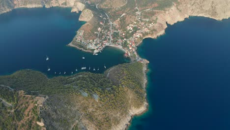 High-aerial-revealing-picturesque-fishing-village-of-Assos-peninsula-in-island-of-Kefalonia