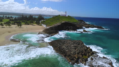 Lighthouse-in-Arecibo-Puerto-Rico-with-waves-crashing-against-rocks,-slow-motion