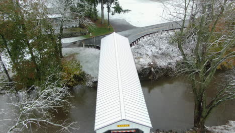 Top-view-of-wooden-covered-bridge-in-Pennsylvania,-Kellers-Mill-in-Lancaster-County,-PA-thin-layer-of-fresh-snow-covering-the-landscape