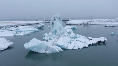Aerial-orbiting-shot-of-icebergs-flowing-on-Glacier-Lake-named-Jo-kulsa-rlo-n-in-Iceland---Close-up-shot
