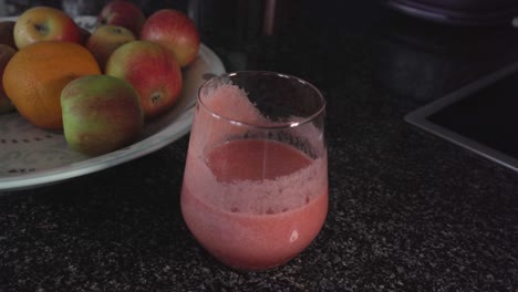 Footage-of-a-smoothie-in-a-glass-and-a-plate-of-fruit