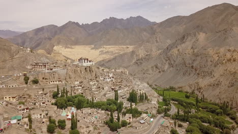 Scenic-Aerial-View-Of-The-Ancient-Lamayuru-Monastery-On-The-Rocky-Hilltop-In-Ladakh,-India---pullback-drone-shot