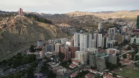 Aerial-Establishing-Shot,-La-Paz-Bolivia-Skyscrapers-Viewpoint-Streets-Mountain-Range-of-Andean-Cordillera,-Clear-Daylight
