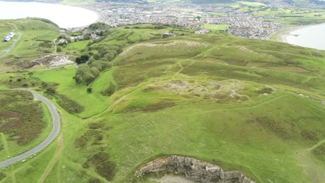 Great-orme-summit-aerial-orbit-left-view-hill-of-names-hillside-stone-words-attraction-mountain-artwork-Llandudno