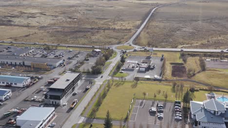 Sunny-day-at-remote-town-Hveragerði-in-Iceland-with-building-and-offices,-aerial