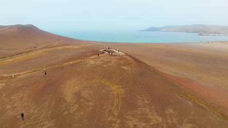 Flying-over-a-view-point-at-Paracas-National-Park-in-Peru-as-tourists-admiring-the-beauty-of-nature
