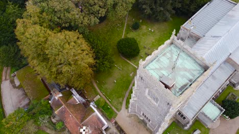Flying-over-St-Michael's-church-tower-in-Framlingham,-England---aerial-top-down-drone-shot