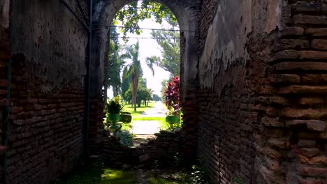 Walking-through-stone-brick-archway-ruins-of-Misión-Jesuitica,-San-José-de-Lules