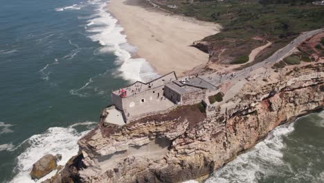 Aerial-top-view-lighthouse-on-a-cliff-on-the-coast-of-the-Atlantic-ocean-in-Nazar?