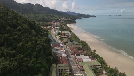 aerial-fly-over-of-Tropical-island-village-with-jungle-beach-and-tourism-resorts-on-Koh-Chang