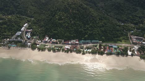 Aerial-tracking-shot-of-touristic-beach-location-with-resorts-and-beach-in-Koh-Chang,-Thailand