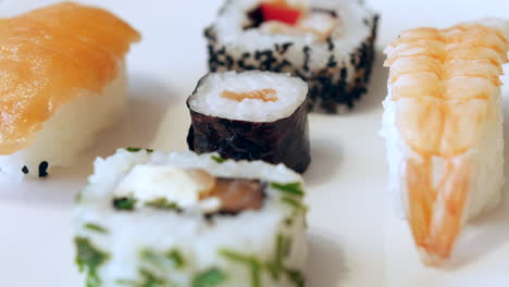 Rack-focus-shot-of-sushi-rolls-on-a-white-plate