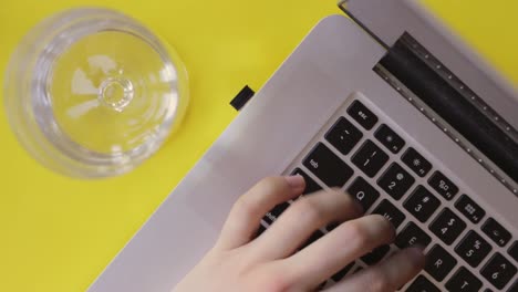 Co-working-space-typing-blogging-on-a-yellow-backdrop