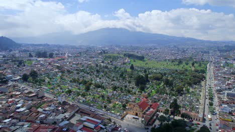 Drone-aerial-footage-of-urban-colonial-graveyard-cemetery-burial-grounds-churchyard-Cementerio-General-in-Central-American-highlands-city-Quetzaltenango,-Xela,-Guatemala-on-a-bright-sunny-day