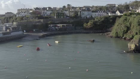 Aerial-over-boat-launch-at-Stoney-Cove-in-Dunmore-East-town,-Ireland