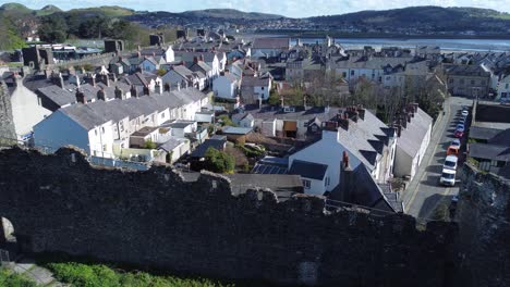 Welsh-holiday-cottages-enclosed-in-Conwy-castle-stone-battlements-walls-aerial-view-jib-up-left