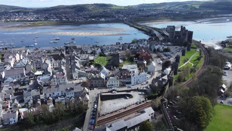 Welsh-holiday-cottages-enclosed-in-Conwy-castle-stone-battlements-walls-aerial-view-rising-high-shot