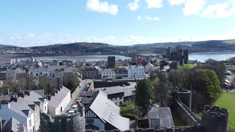 Welsh-holiday-cottages-enclosed-in-Conwy-castle-stone-battlements-walls-aerial-view-rising-river-reveal