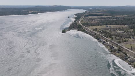 Frozen-Water-Of-Magog-River-During-Winter-In-Canada---aerial-shot