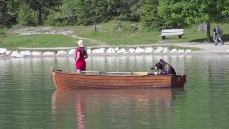 A-photo-shoot-of-a-pregnant-woman-using-a-rowing-boat-on-lake-Braies,-South-Tyrol,-Italy