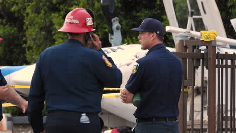 Helicopter-crashed-in-a-residential-backyard,-firefighters-at-the-helicopter-incident,-yellow-tape