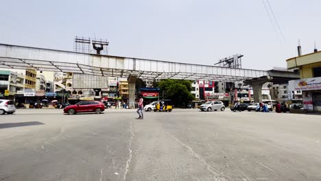 A-man-is-seen-crossing-the-street,-and-several-cars-and-a-lorry-can-be-seen-passing-from-one-side-to-the-other-behind-him