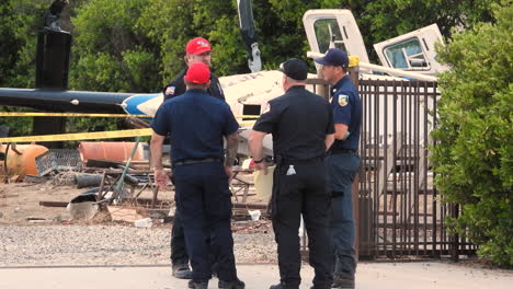 Police-officers-talking-and-guarding-crash-site-of-emergency-helcipter