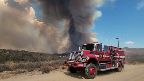 Camión-De-Bomberos-Seco-De-Incendios-Forestales-De-California-Conduce-Un-Gran-Día-De-Cielo-Azul-Claro-De-Humo-Negro
