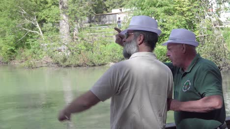 Two-men-wearing-white-hats-pointing-and-looking-at-something-in-the-distance-whilst-talking-about-it