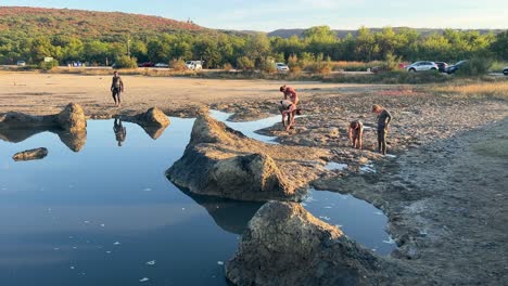 People-applying-mud-in-Cizici-on-Krk-island,-Kvarner-bay-of-Croatia