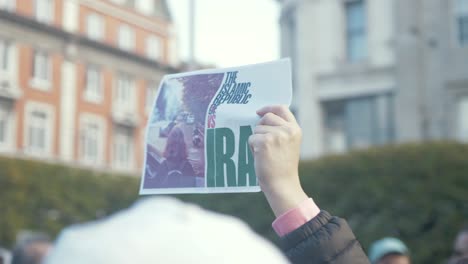 Protester-holding-up-Anti-Iranian-Regime-poster-after-death-of-Mahsa-Amini