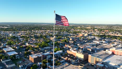 Allentown-Pennsylvania-aerial-orbit-of-American-flag-during-summer-golden-hour-light