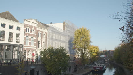 Beautiful-old-houses-near-Dutch-canal-with-buildings-under-renovation