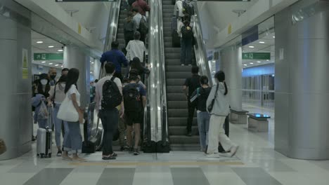 Llegar-A-La-Estación-De-Tren-Subterráneo-En-El-Aeropuerto-Usando-Una-Escalera-Mecánica