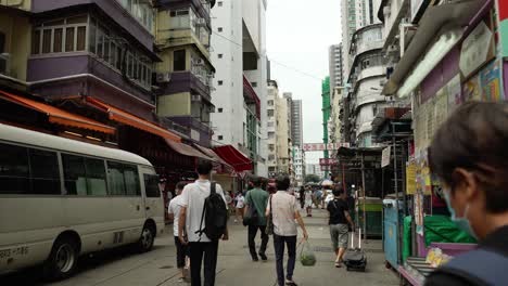 The-camera-follows-the-busyness-of-workers-walking-on-the-street